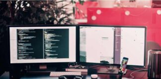 Mastering eCommerce Web Development: Your Ultimate Guide Two black computer monitors on black table