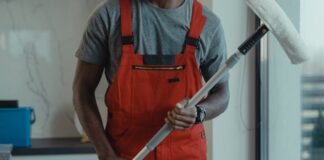 Common Mistakes in Commercial Property Maintenance and How to Avoid Them Man wearing an orange coveralls