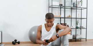 Essential Equipment for a Complete Home Gym Setup Man Sitting on a Yoga Mat