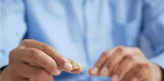 Loan Rangers – Which Business Loan is Right For Your Company? A person stacking coins on top of a table