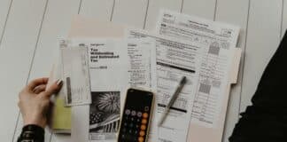 Return Relief: 12 Proven Tips to Take the Pressure Out of Tax Time Person holding paper near pen and calculator