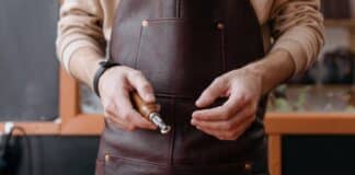 7 Leather Tools That Make Complex Projects Effortless Person Holding a Leather Workshop Tool