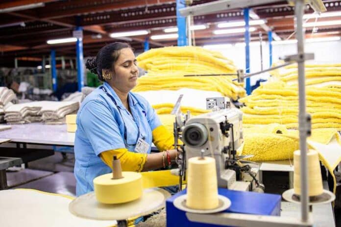 Textile Factory Worker Operating Sewing Machine